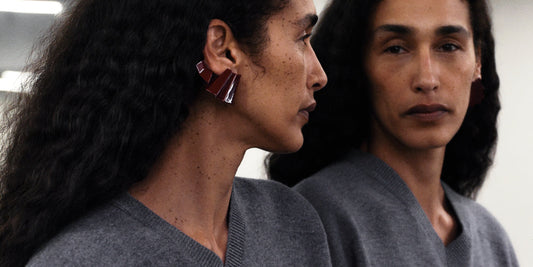 Phoebe Philo grey V-neck knit and sculptural oxblood earring, mirror reflection