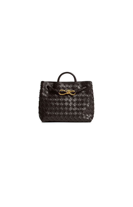 Brown woven handbag with gold logo on a white background