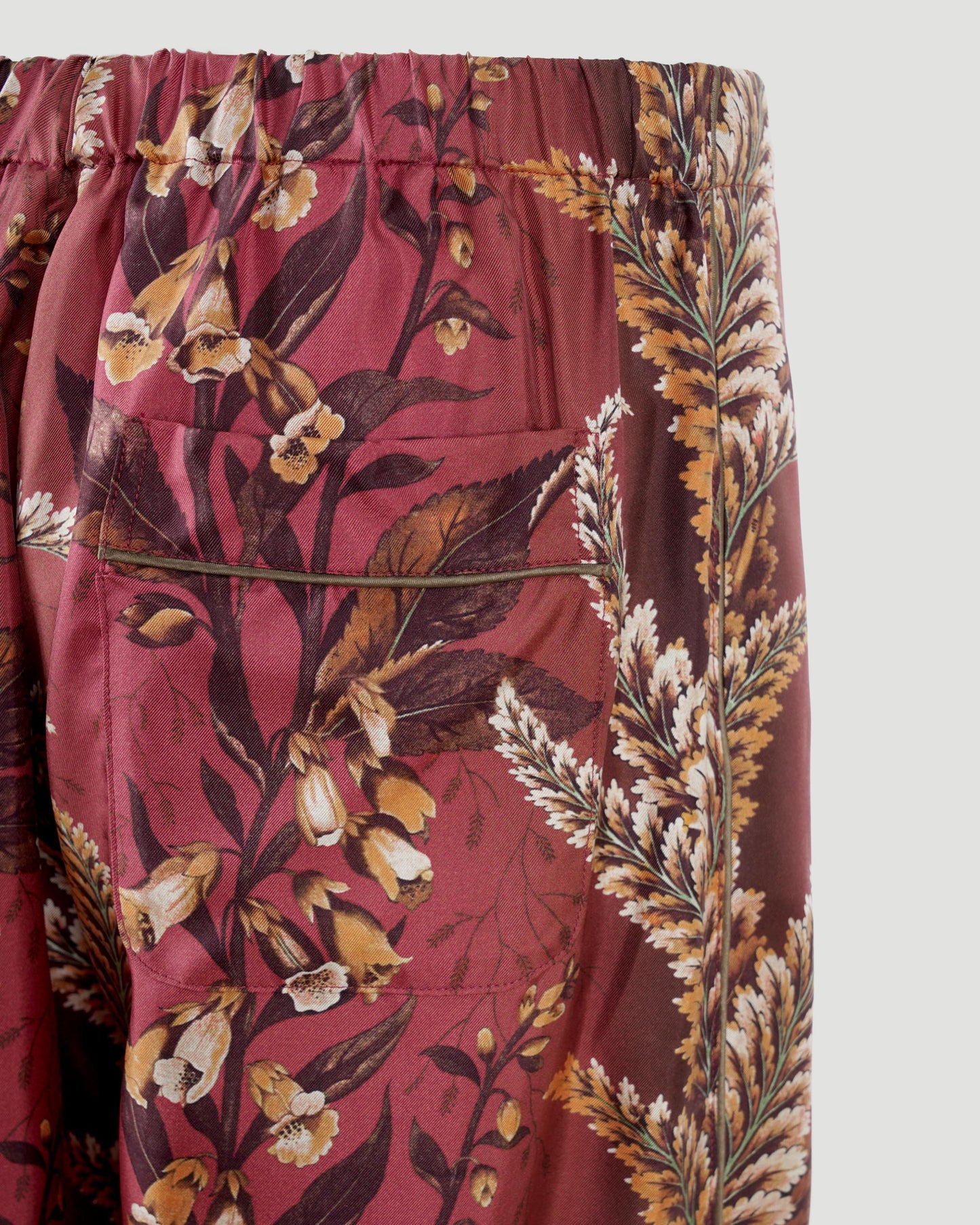 SILK PANTS WITH FLORAL MOTIF IN BRICK RED