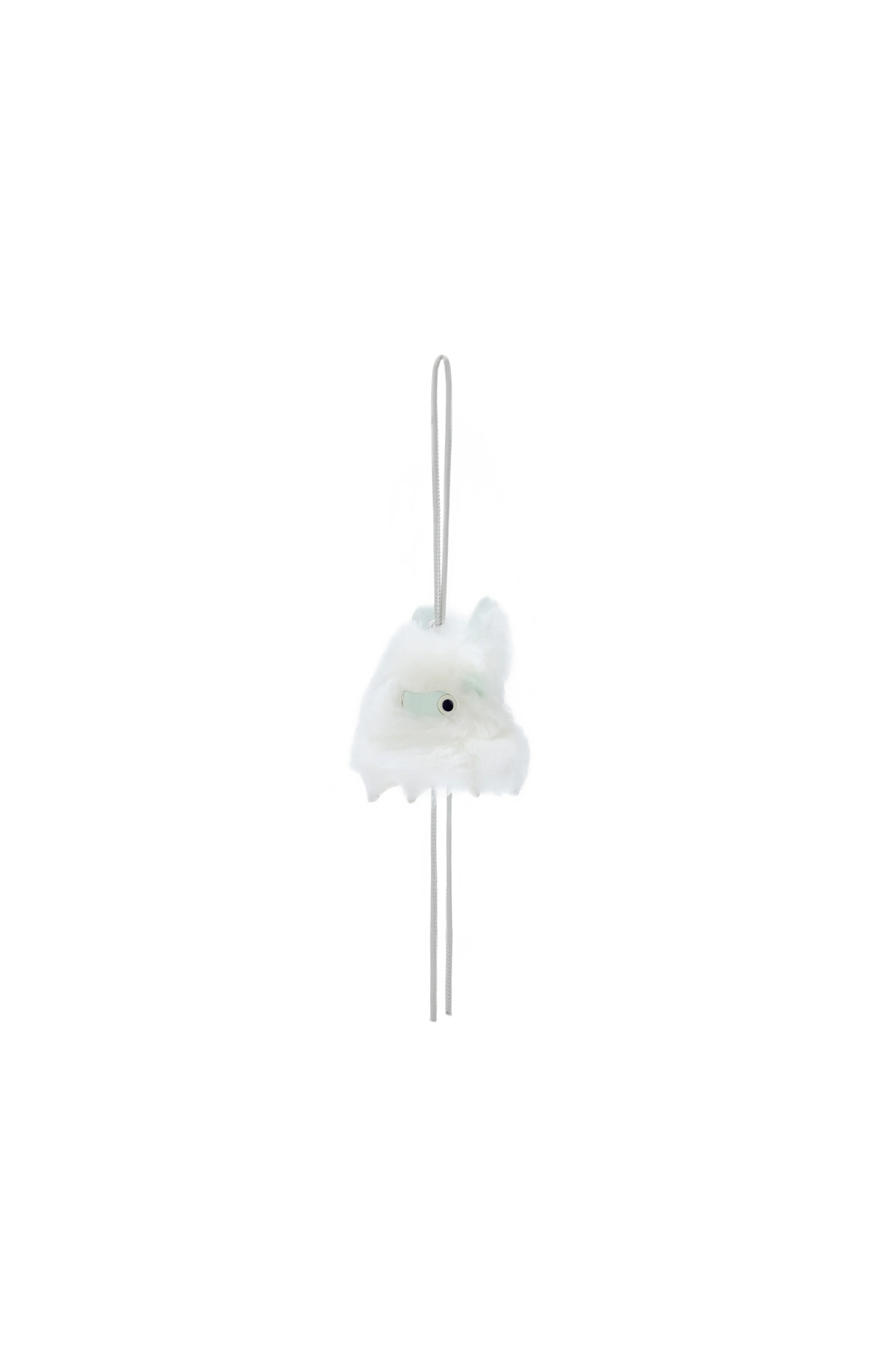 White decorative item with a long thin rod on a white background