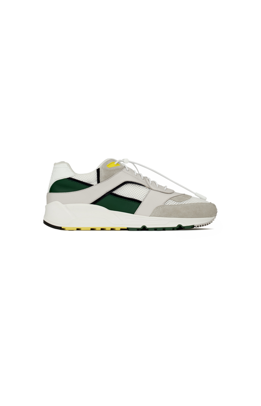 White sneaker with green accents on a white background